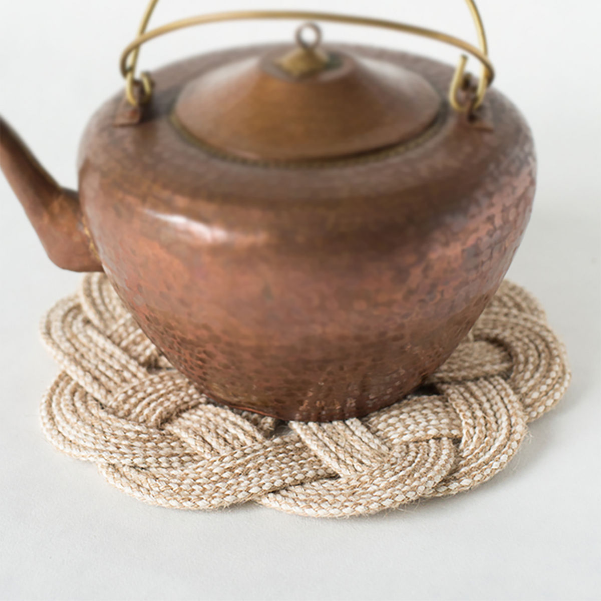 Braided cotton trivet with a copper kettle, portable kitchen safety accessory by Kontenl KTL